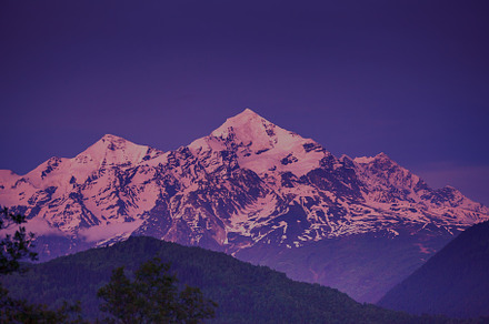 Sunset evening view over the snowy mountain peak stock photo containing